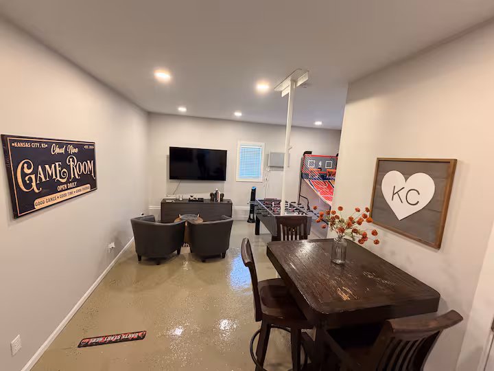 Game room with foosball, arcade hoops, and KC art